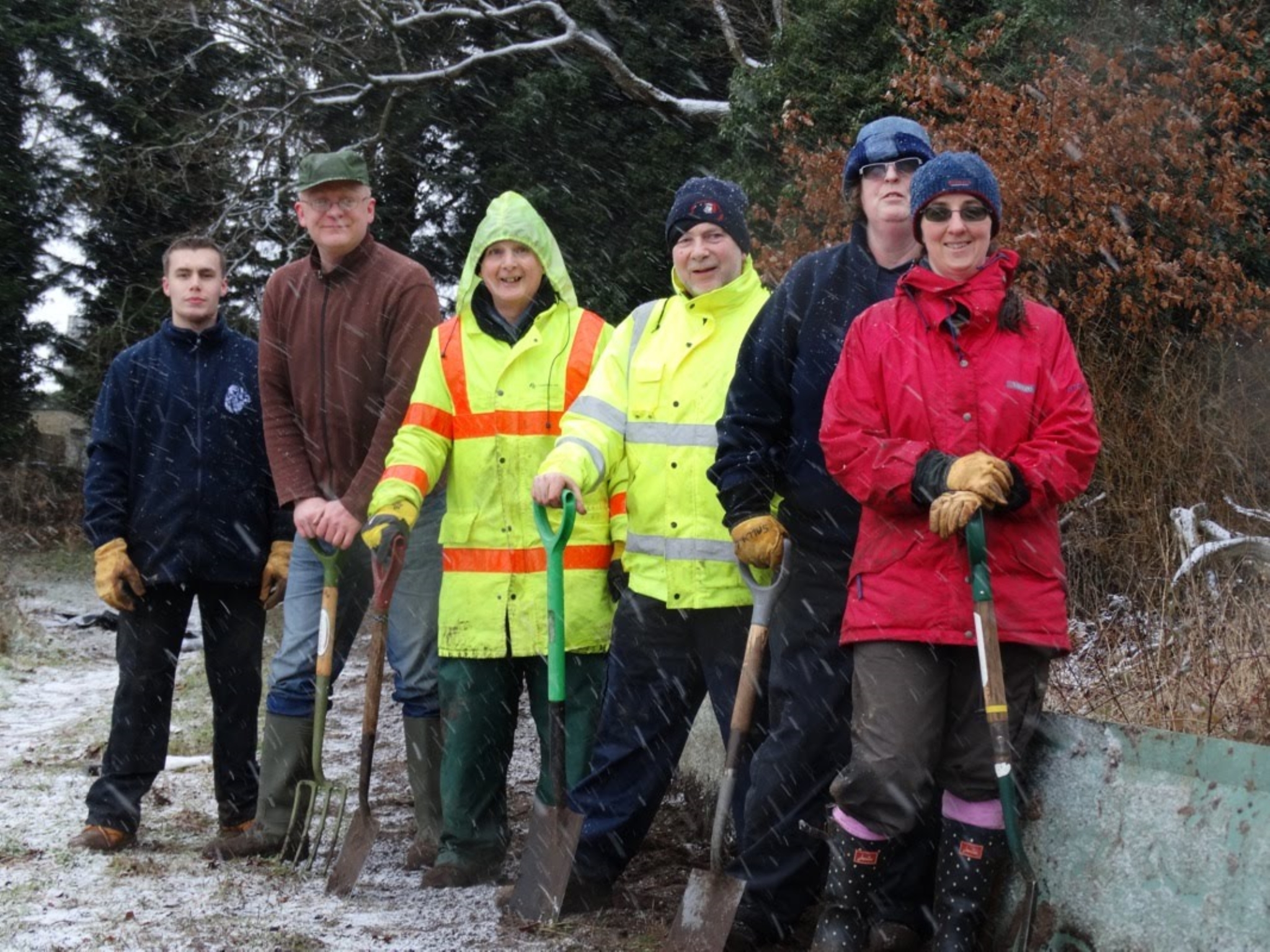 A photo from the FoTF Conservation Event - January 2018 - Erecting the Toad Fence at Cranwich : A group photo of of the volunteers standing beside a section of the erected fence