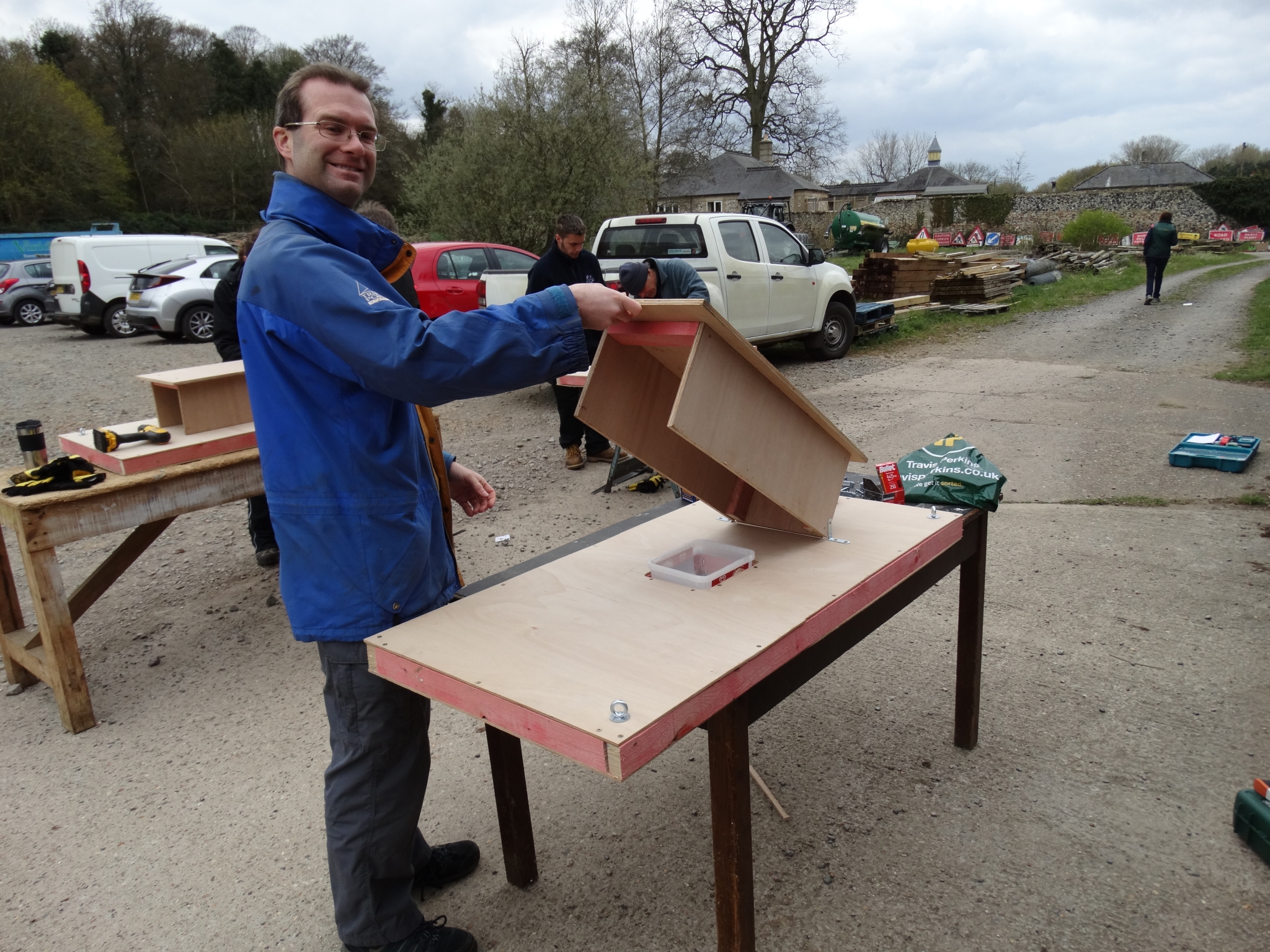 A photo from the FoTF Conservation Event - April 2019 - Mink Raft Construction at Santon Downham Workshops : A volunteer proudly display a mink raft component